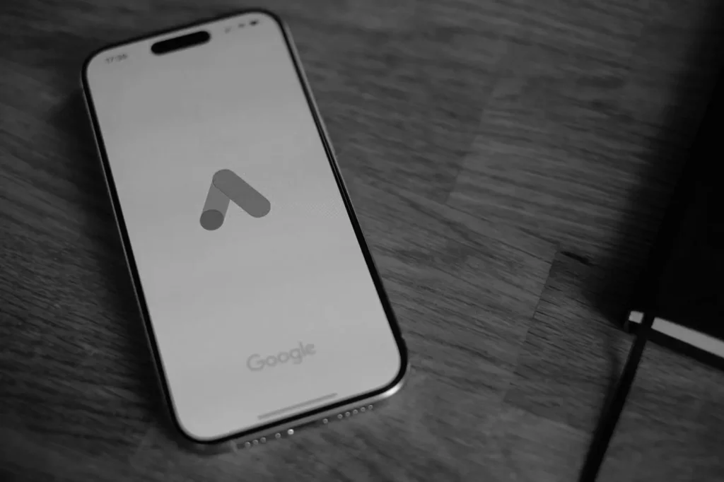 a phone on the table with google ads logo by best freelance digital marketer in Thrissur